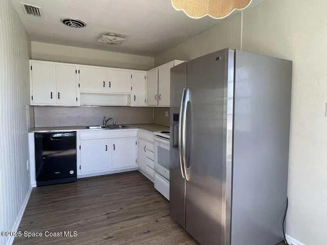 a kitchen with stainless steel appliances a refrigerator sink and cabinets