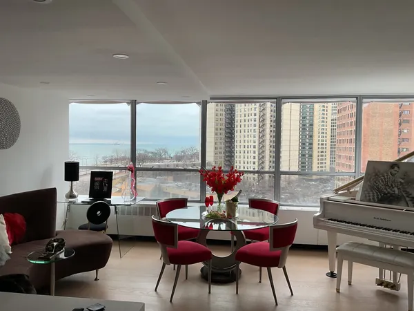 a living room with furniture and floor to ceiling window