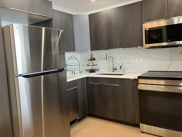 a kitchen with a refrigerator and microwave