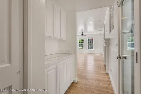 a view of a hallway with wooden floor