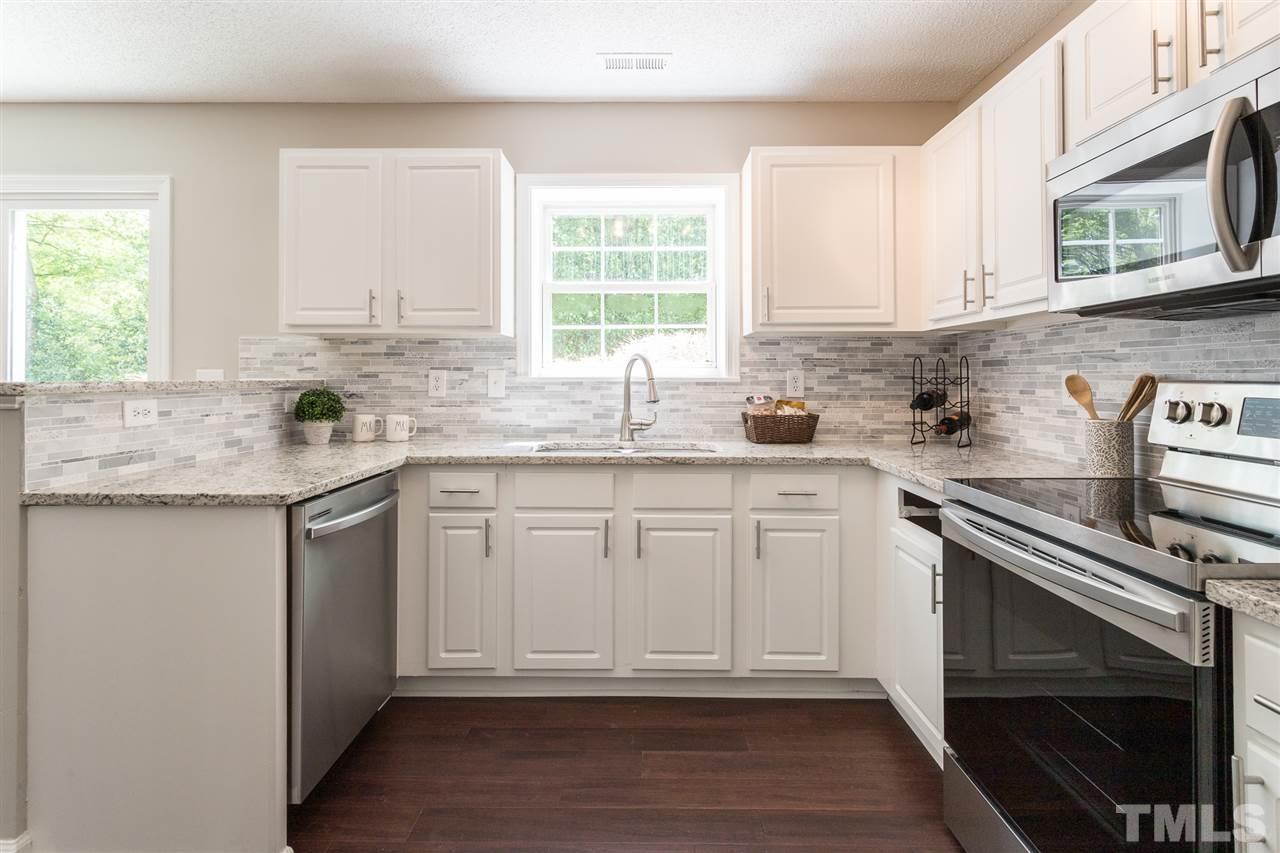 4628 Drewbridge Way Raleigh, NC 27604 - Photo 2 of 21 a kitchen with stainless steel appliances granite countertop a sink stove and cabinets