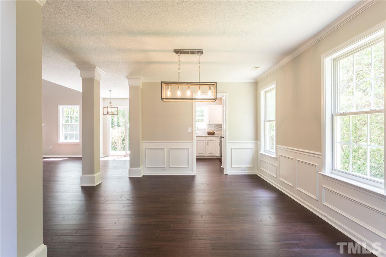 4628 Drewbridge Way Raleigh, NC 27604 - Photo 11 of 21 a view of an empty room with wooden floor and a window
