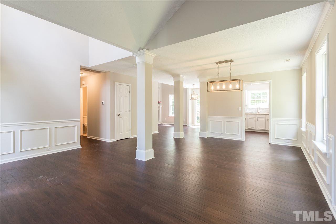 4628 Drewbridge Way Raleigh, NC 27604 - Photo 12 of 21 a view of an empty room with window and wooden floor