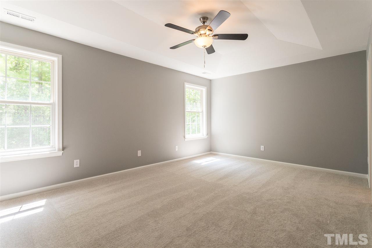4628 Drewbridge Way Raleigh, NC 27604 - Photo 13 of 21 an empty room with a window and a fan