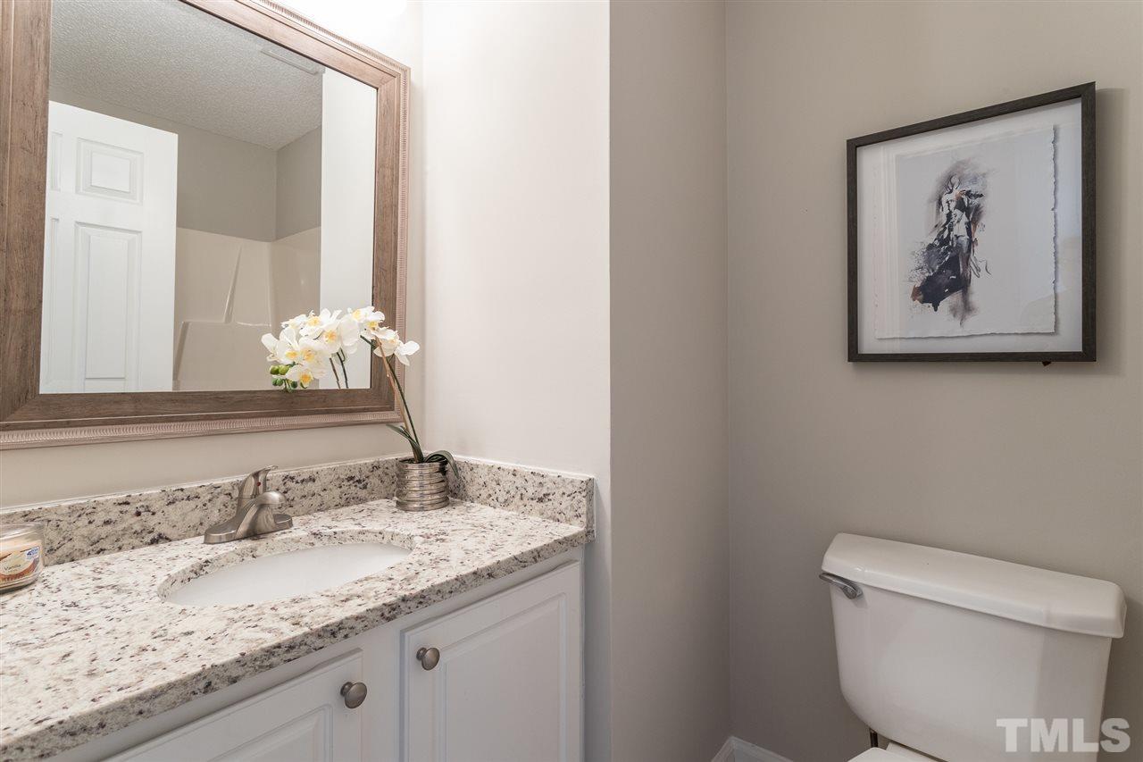4628 Drewbridge Way Raleigh, NC 27604 - Photo 16 of 21 a bathroom with a granite countertop sink and a toilet
