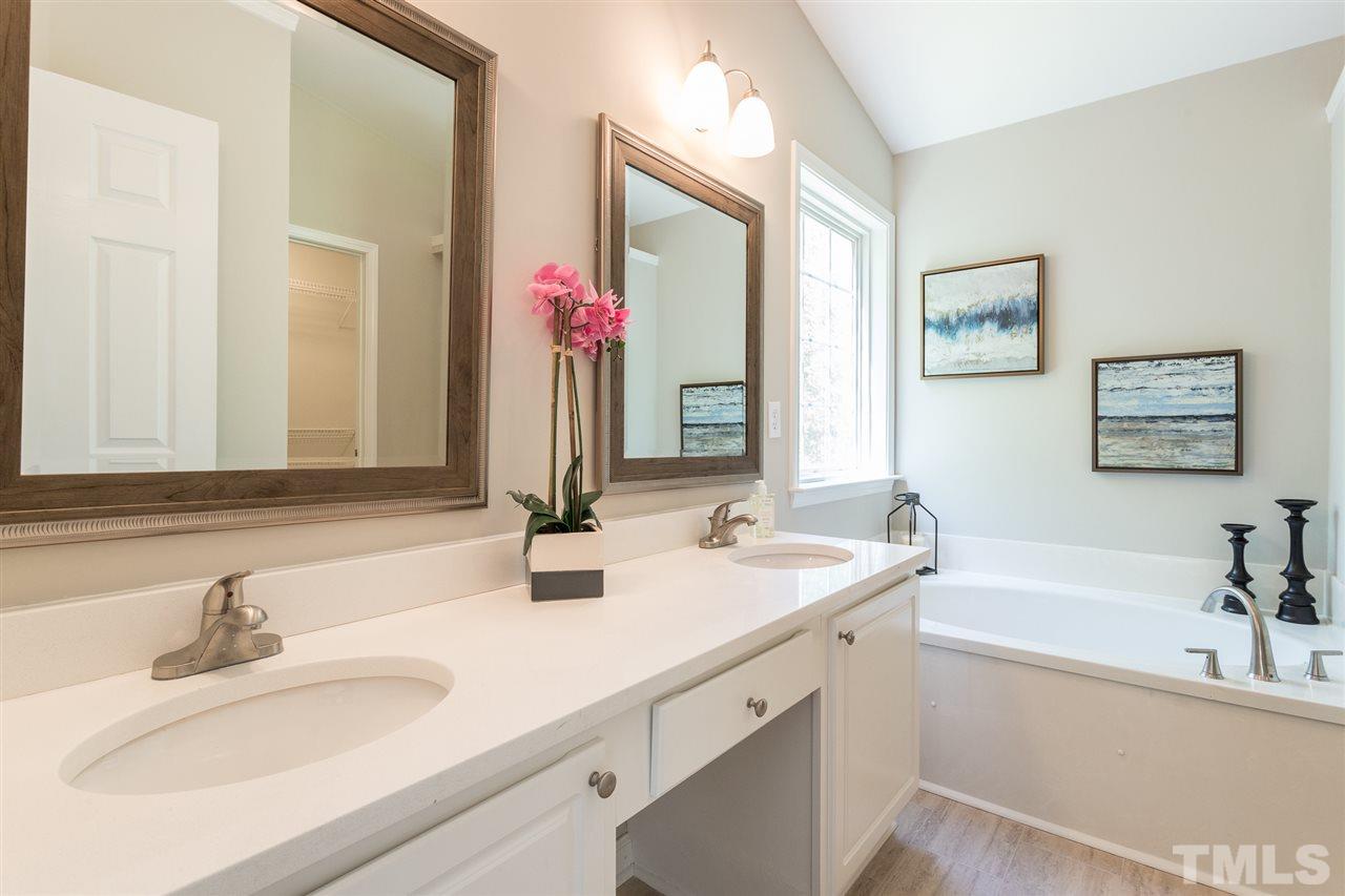 4628 Drewbridge Way Raleigh, NC 27604 - Photo 6 of 21 a bathroom with a tub sink and mirror