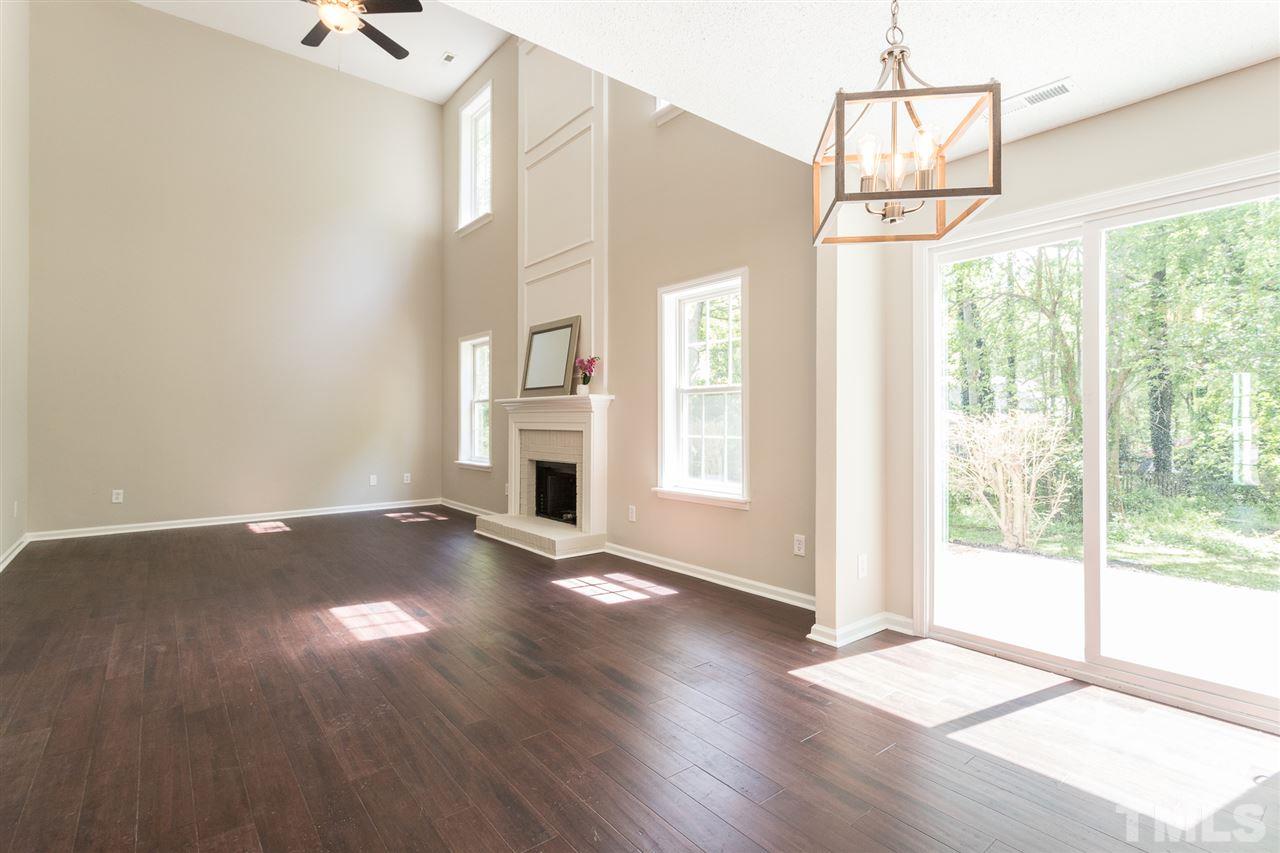 4628 Drewbridge Way Raleigh, NC 27604 - Photo 10 of 21 a view of an empty room with wooden floor and a window