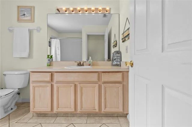 a bathroom with a sink vanity and mirror