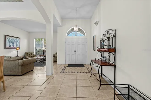 a living room with furniture a rug and a window