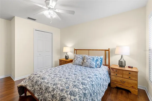 a bedroom with a bed and a lamp on table