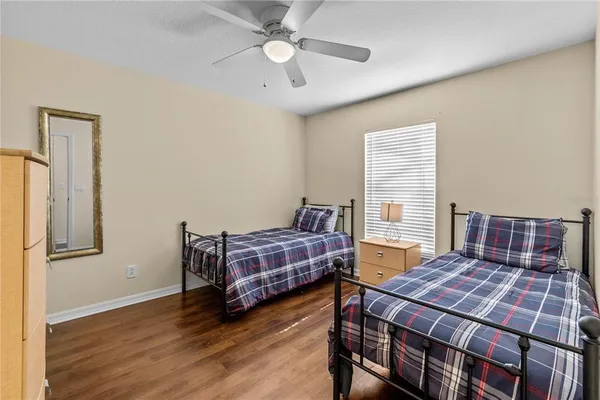 a bedroom with a bed and wooden floor