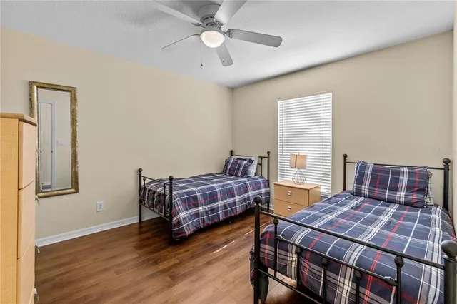 a bedroom with a bed and wooden floor