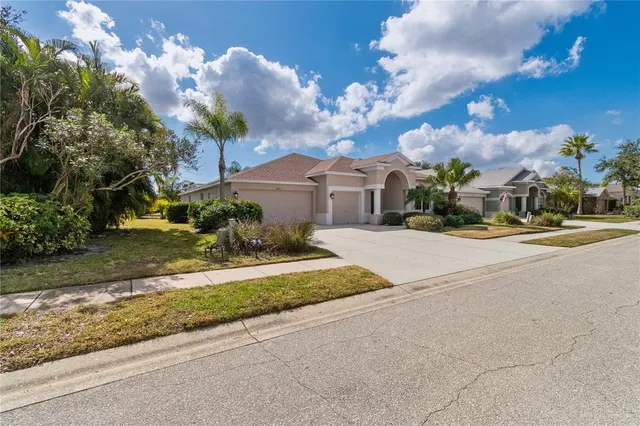 a front view of a house with a yard and a garage