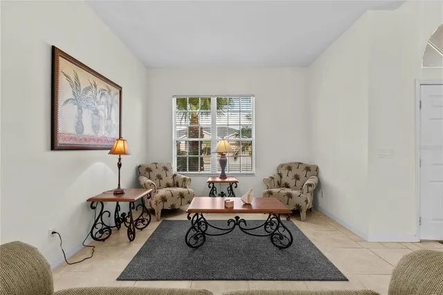 a living room with furniture a window and a table