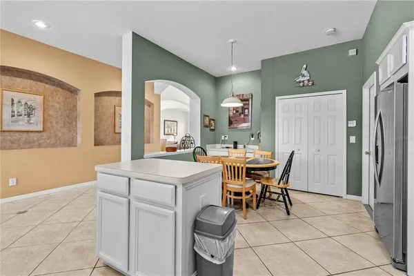 a view of a dining room with furniture and a chandelier