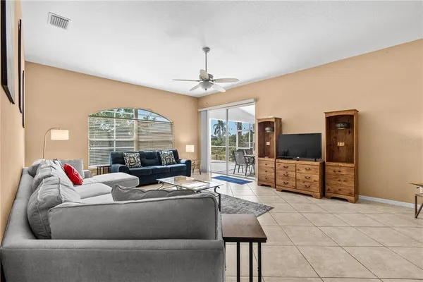 a living room with furniture and a chandelier