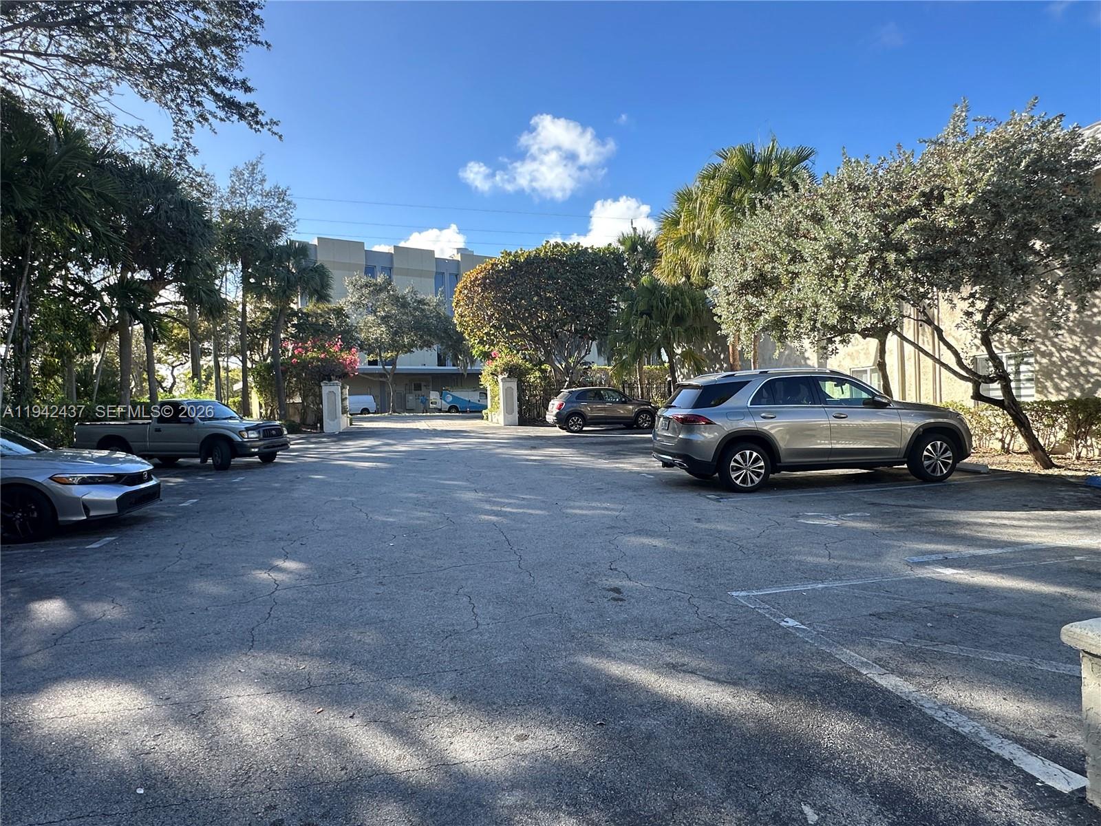 8605 Southwest 68th Court, Unit 26 Pinecrest, FL 33156 - Photo 19 of 21 a view of street with parked cars