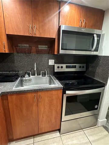 a kitchen with a sink and a microwave