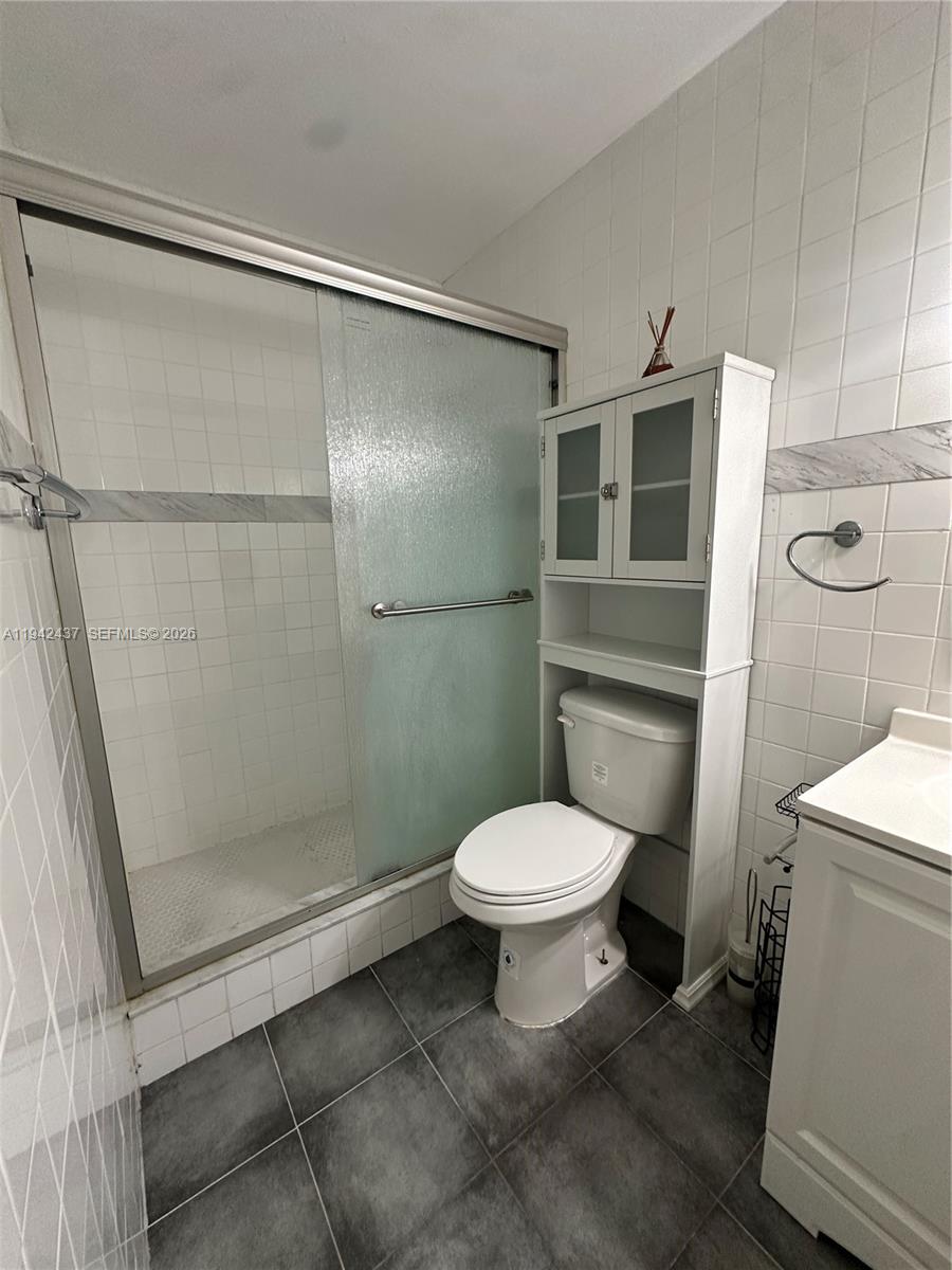 8605 Southwest 68th Court, Unit 26 Pinecrest, FL 33156 - Photo 10 of 21 a bathroom with a toilet and a shower