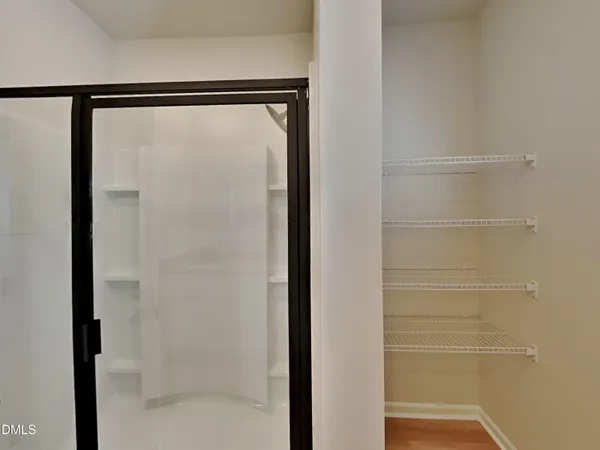 a bathroom with a glass shower door