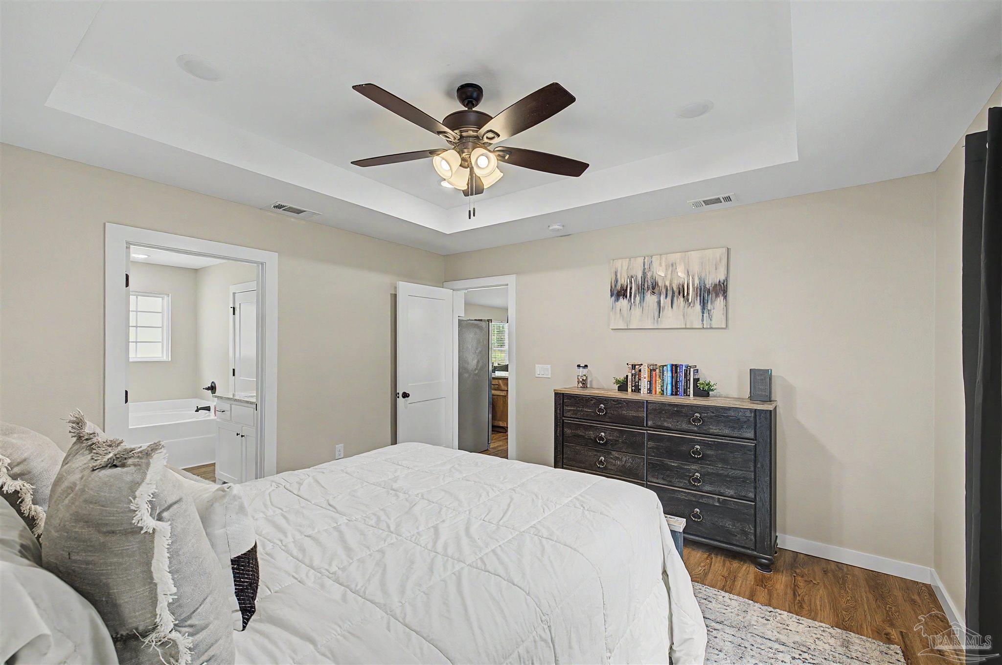 2549 Ten Mile Road Pace, FL 32571 - Photo 30 of 46 a bedroom with a bed and a chandelier