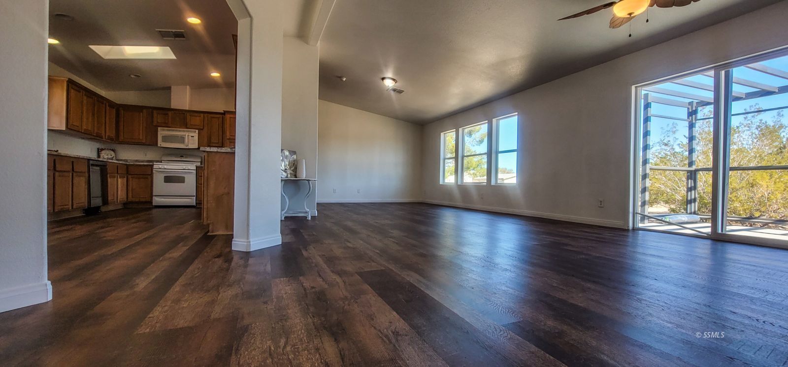 1056 North Alford Street Ridgecrest, CA 93555 - Photo 4 of 24 a view of an empty room with wooden floor and a window