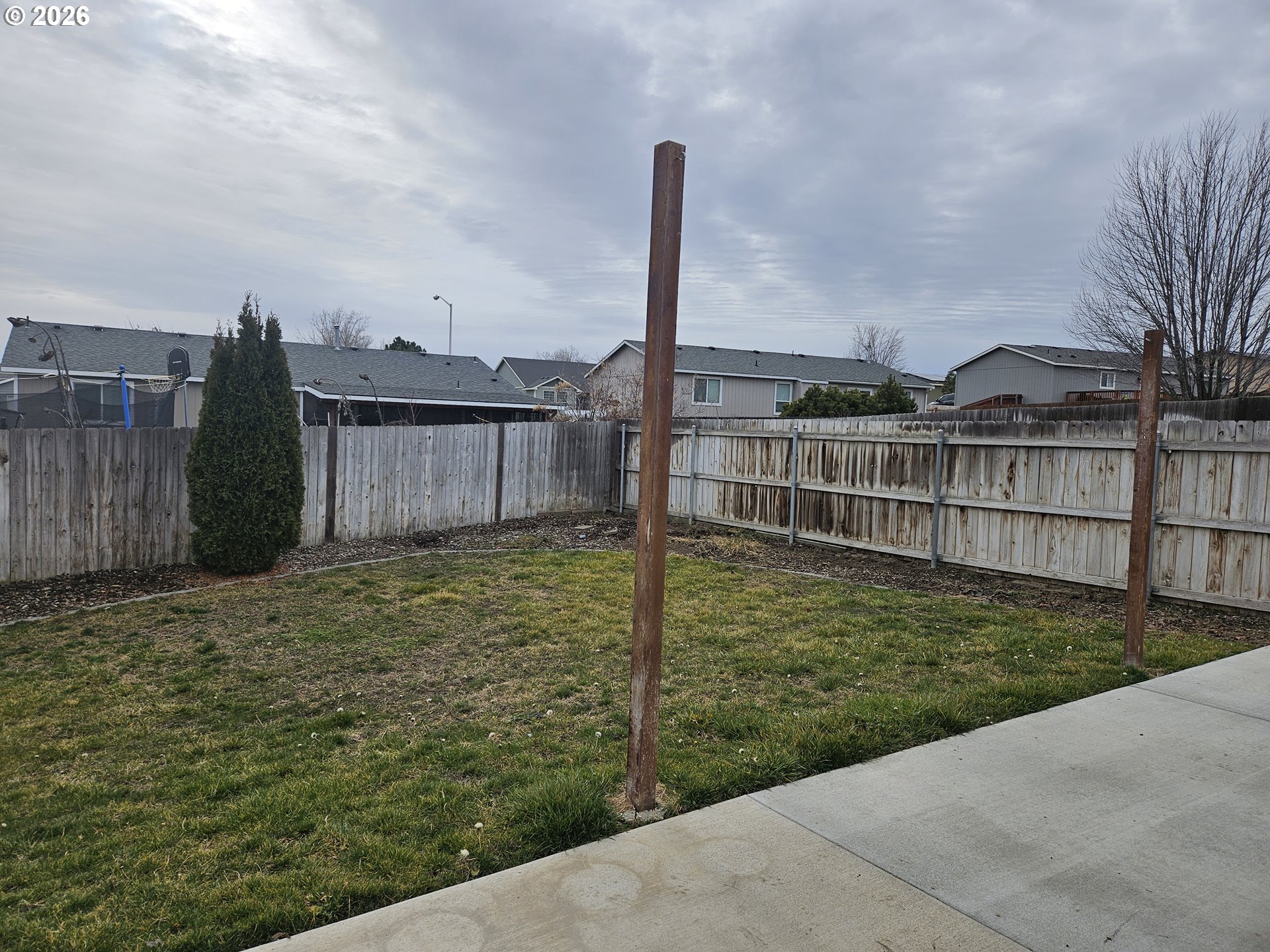 125 Teal Court Stanfield, OR 97875 - Photo 19 of 21 a view of a backyard with floor to ceiling windows