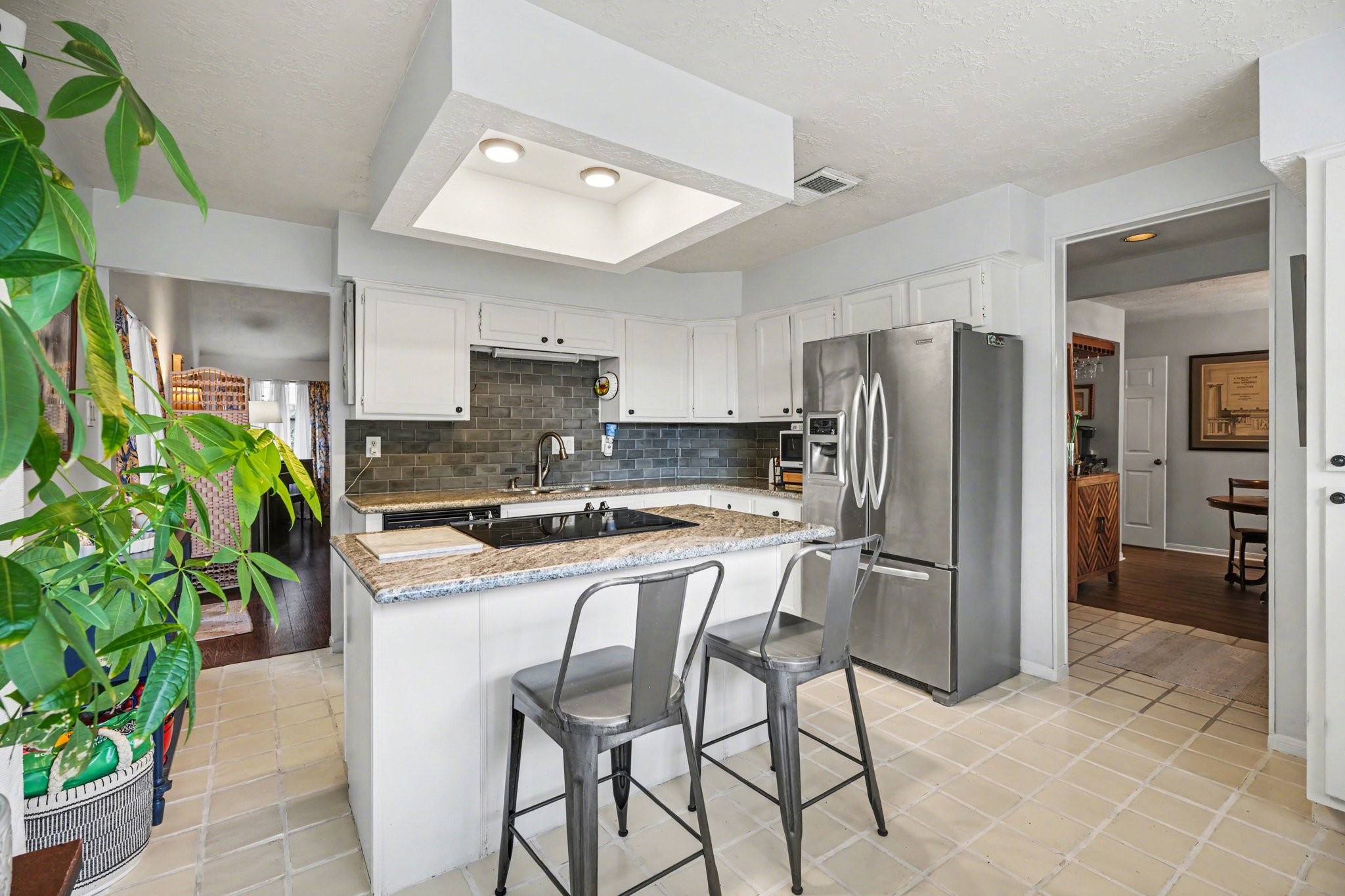 16810 Finewood Way Houston, TX 77058 - Photo 12 of 23 Kitchen offers ample cabinet storage along with an island featuring convenient breakfast bar seating.