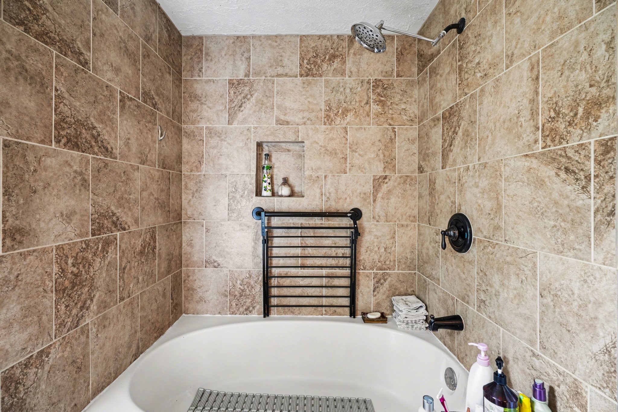 16810 Finewood Way Houston, TX 77058 - Photo 18 of 23 Relaxing garden tub and shower combination with a gorgeous tile surround.