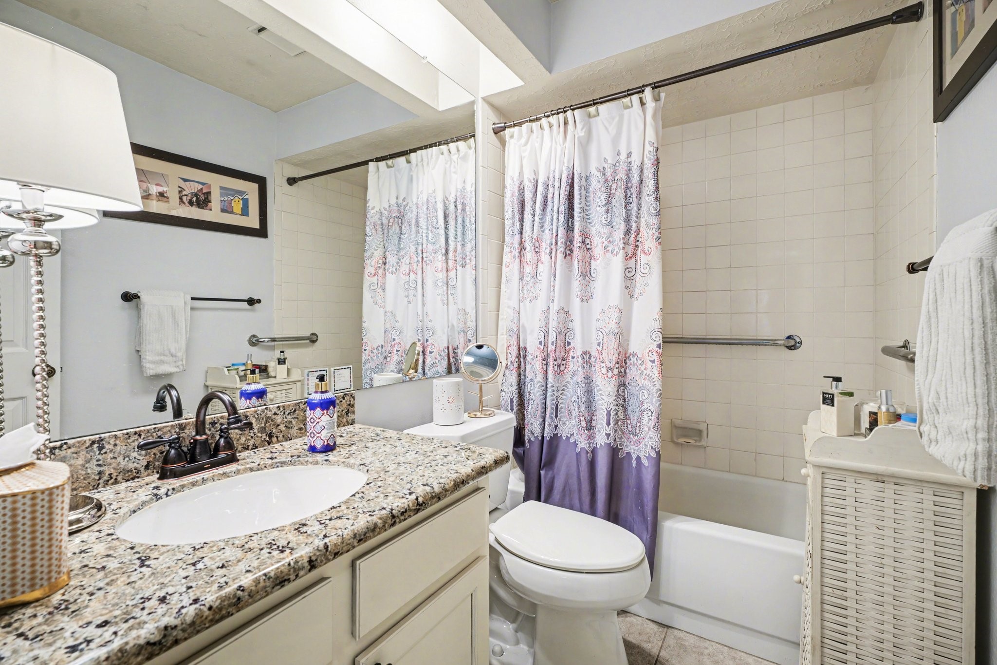 16810 Finewood Way Houston, TX 77058 - Photo 20 of 23 Hall bathroom features granite countertops and a tub/shower combination with a clean white tile surround.