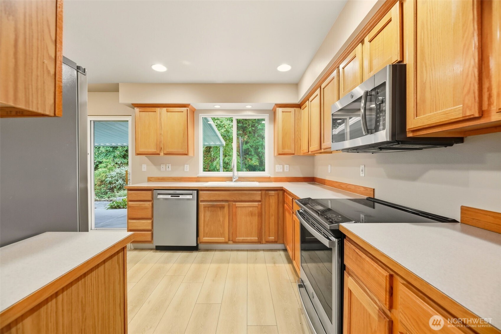 13117 Tonga Ridge Road Southeast Monroe, WA 98272 - Photo 5 of 40 a kitchen with a sink a stove top oven a sink a counter top space and cabinets