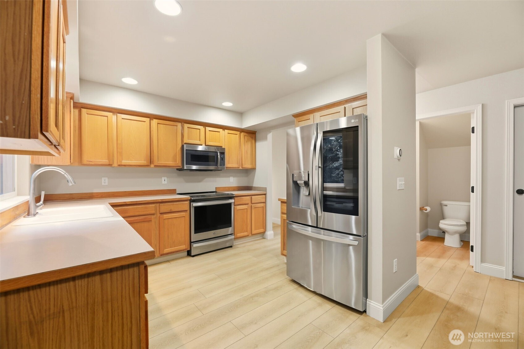 13117 Tonga Ridge Road Southeast Monroe, WA 98272 - Photo 6 of 40 a kitchen with stainless steel appliances granite countertop a refrigerator and a sink