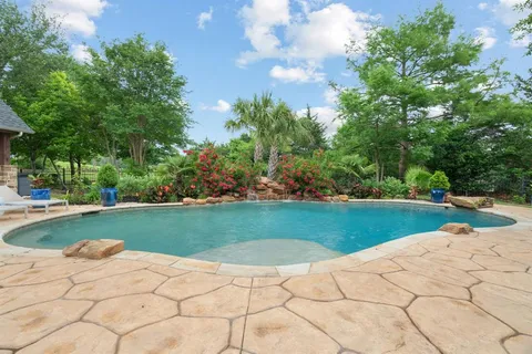a view of a swimming pool and trees in the background