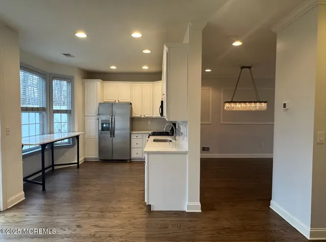 a kitchen with refrigerator and window