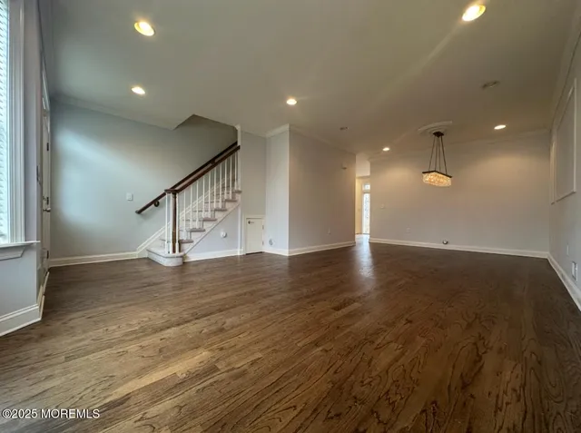 a view of a room with wooden floor and window