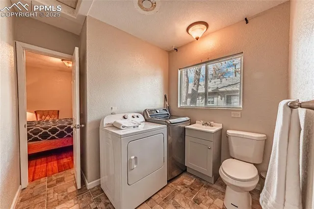 a bathroom with a toilet sink and mirror