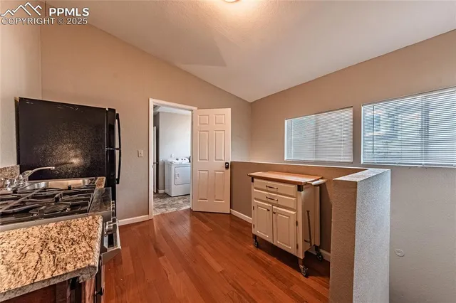 a view of a livingroom with wooden floor and furniture