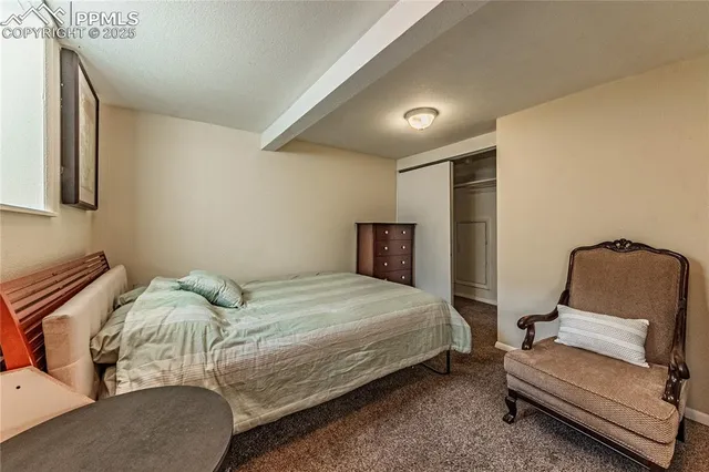 a bedroom with a bed and a chair