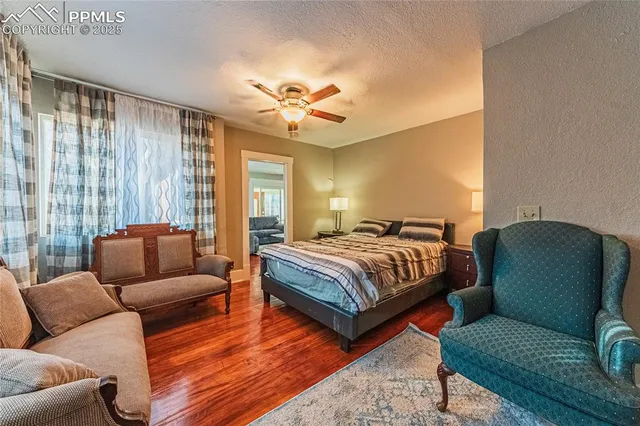 a bedroom with furniture and a large window