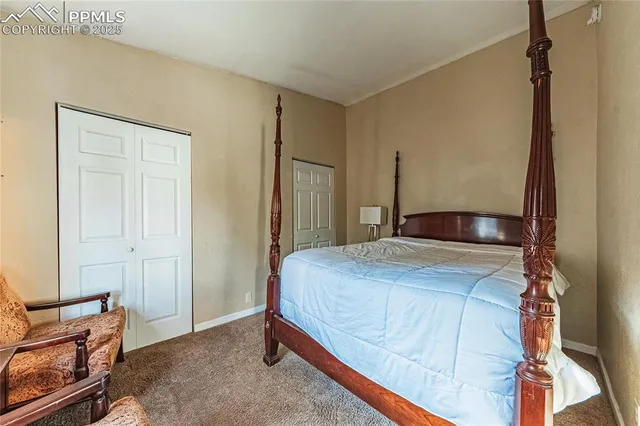 a bedroom with a bed and a dresser in it