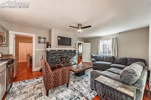 a living room with furniture a flat screen tv and a fireplace