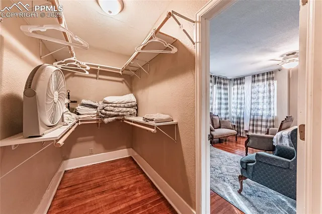 a view of walk in closet with clothes and shoes