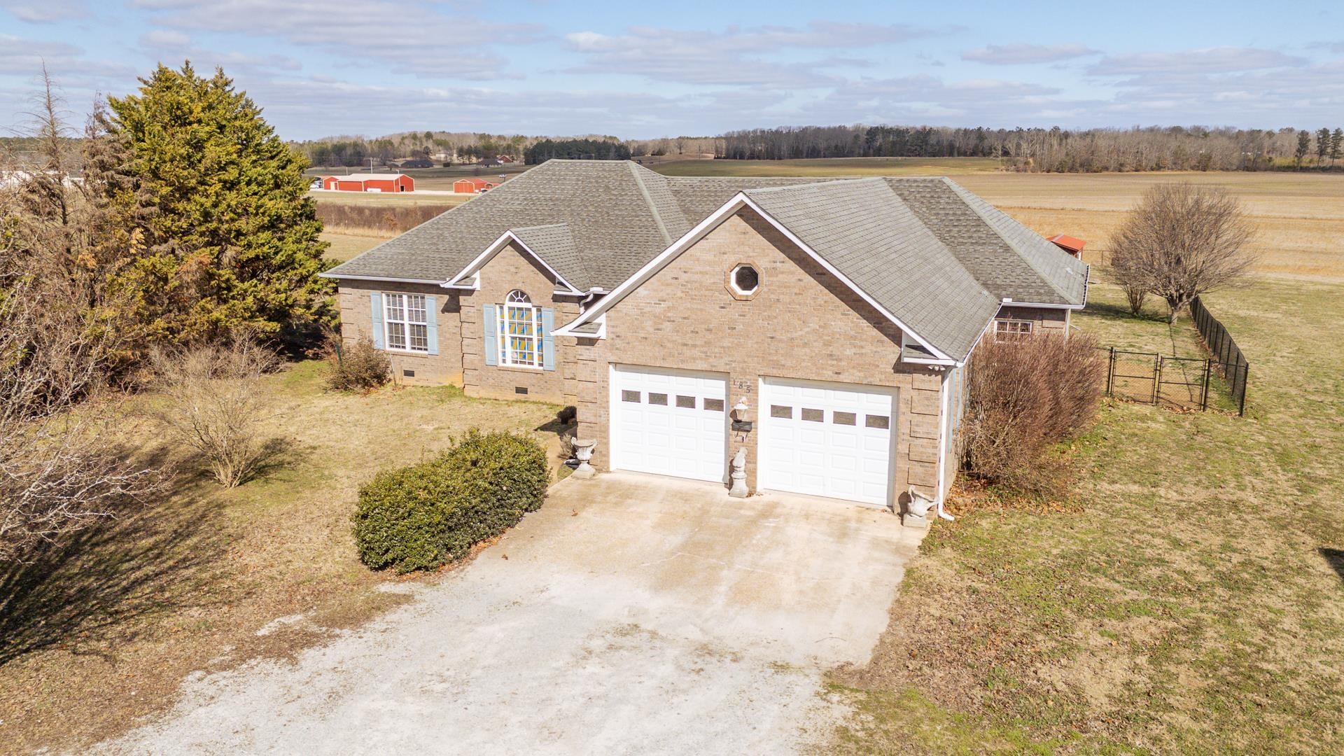 185 Leath Lane Finger, TN 38334 - Photo 1 of 34 a front view of a house with a yard and lake view