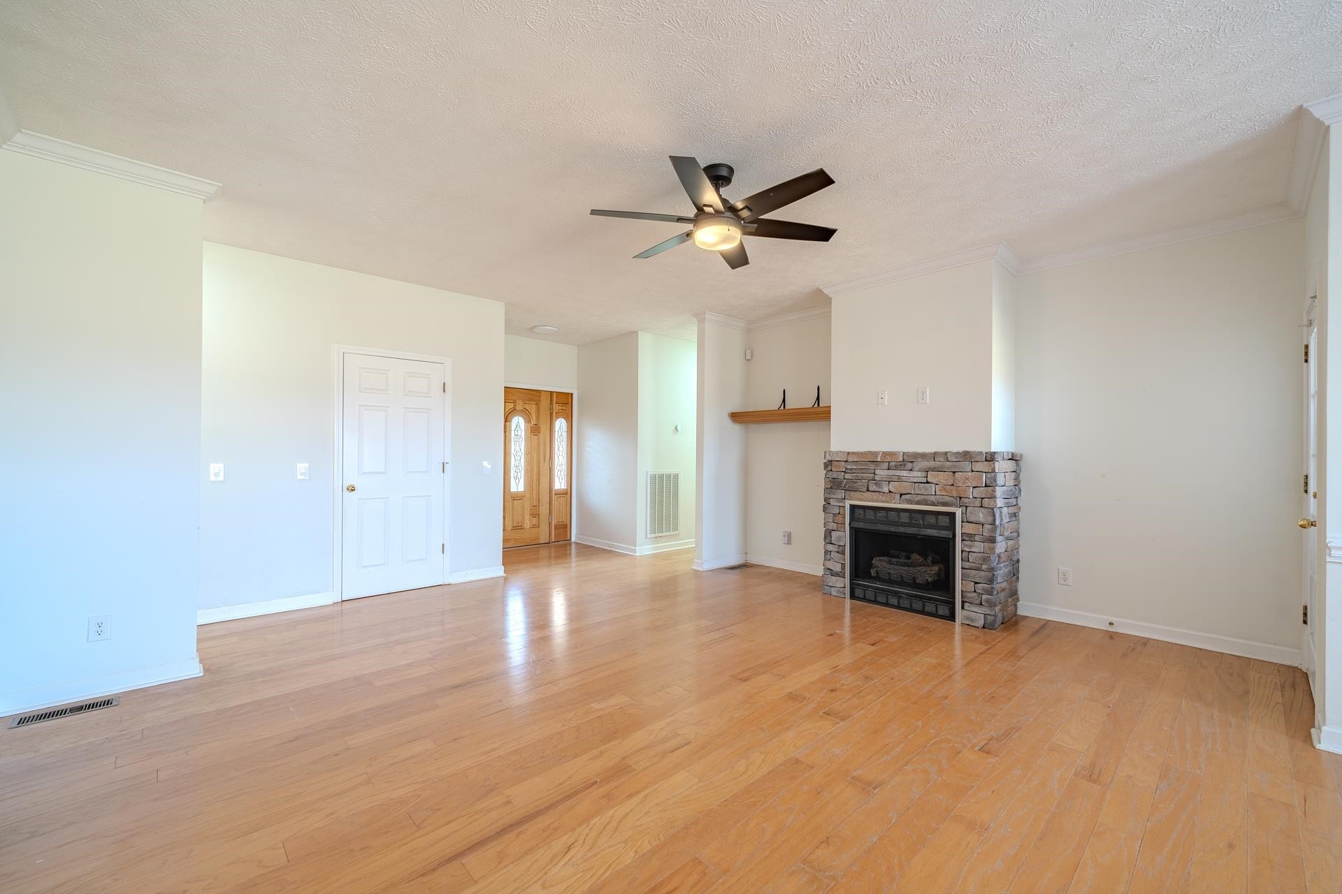 185 Leath Lane Finger, TN 38334 - Photo 8 of 34 a view of empty room with fireplace and ceiling fan