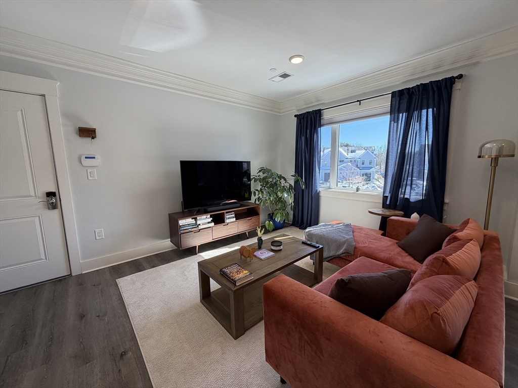 17 Hennery Way, Unit G Medfield, MA 02052 - Photo 3 of 12 a living room with furniture and a flat screen tv