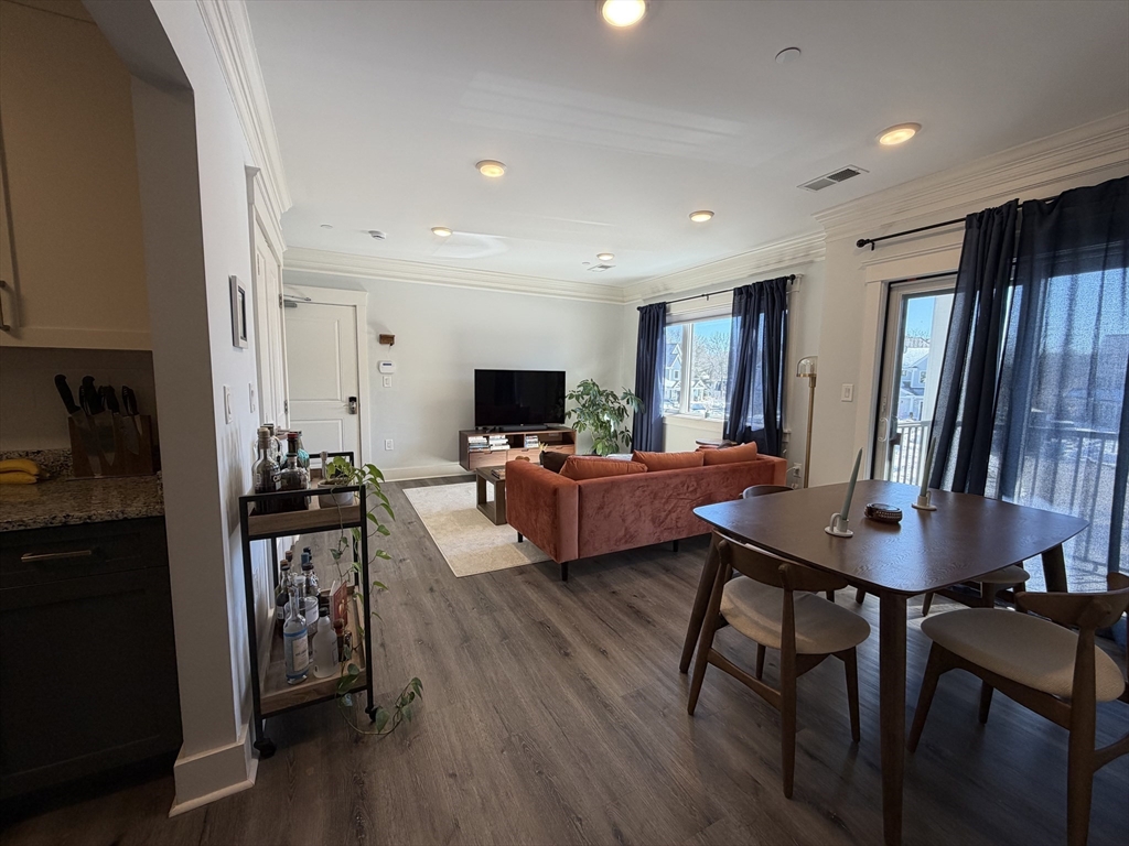 17 Hennery Way, Unit G Medfield, MA 02052 - Photo 6 of 12 a living room with furniture a wooden floor and a window