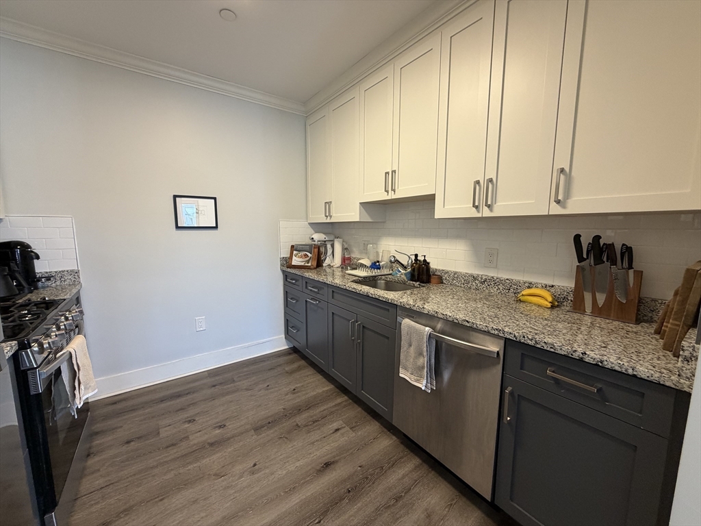 17 Hennery Way, Unit G Medfield, MA 02052 - Photo 8 of 12 a kitchen with granite countertop white cabinets and white appliances