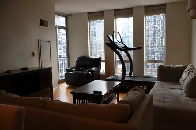 a living room with furniture windows and a flat screen tv