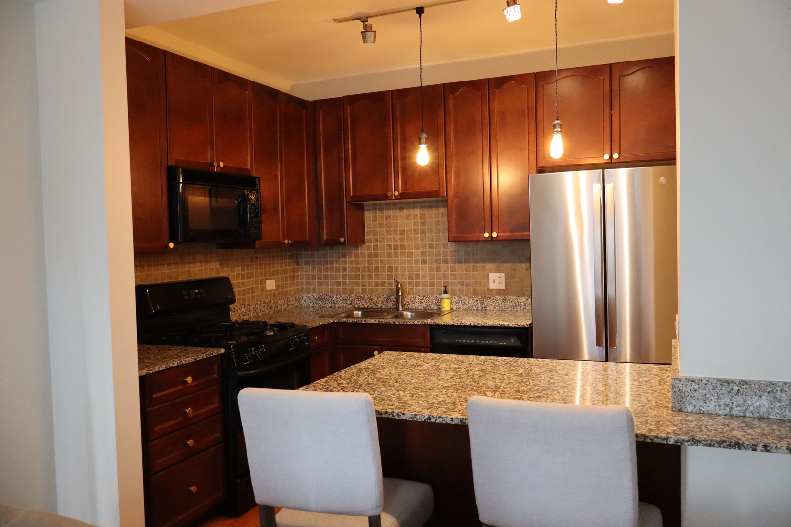 1250 South Michigan Avenue, Unit 1306 Chicago, IL 60605 - Photo 3 of 24 a kitchen with a sink cabinets and refrigerator