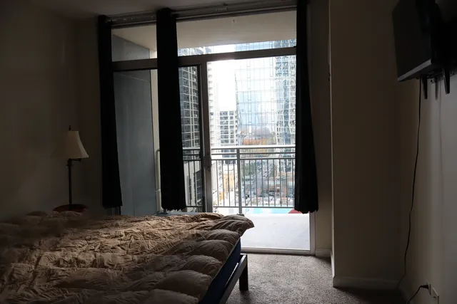 a bedroom with a bed and a window
